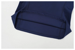 Close-up of fine flatlock stitching and elastic fabric texture on a navy yoga tank top