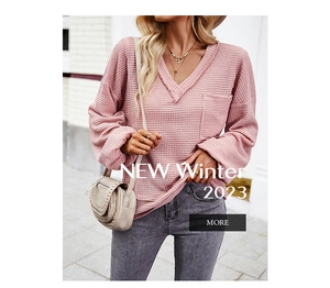 Detail of pink waffle knit sweater texture with V-neck and front pocket design