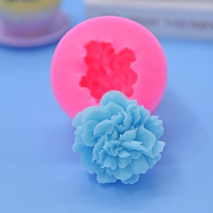Pink silicone mold and blue flower-shaped cake topper for DIY baking and fondant crafts