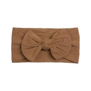 Detailed cable knit texture on caramel brown baby nylon headband with large bow