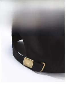 Detail of black cotton baseball cap showing bronze metal adjustable sliding buckle back