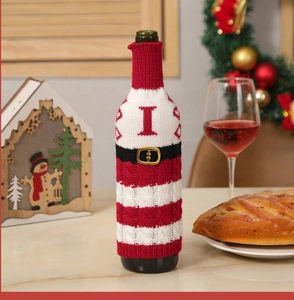 Close-up of Santa suit knitted wine bottle cover with gold buckle for Christmas table decor