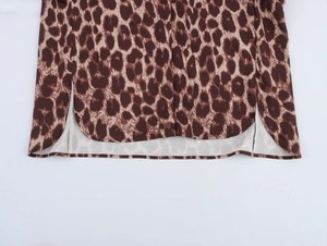 Detailed view of leopard print shirt hem with side split and curved tailoring