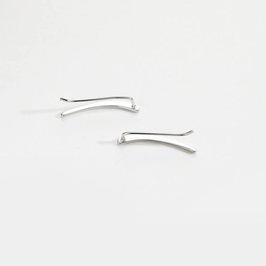 Close-up of minimalist S925 sterling silver curved bar earrings with a polished finish