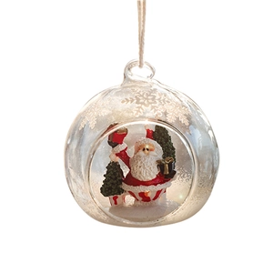 Christmas glass ball ornament with Santa and tree miniature scene on white background