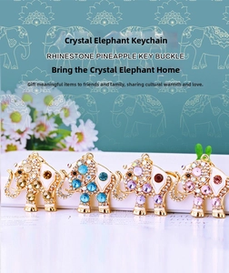 Detailed view of four colorful crystal elephant keychains with gold-toned alloy base