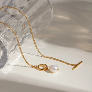 Golden stainless steel necklace with toggle clasp and freshwater pearl pendant display