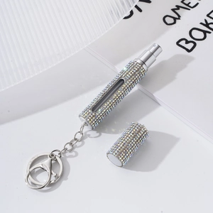 Sparkly rhinestone-covered silver refillable perfume bottle with a metal keychain