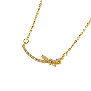 Golden butterfly bow necklace with pavé cubic zirconia pendant on white background