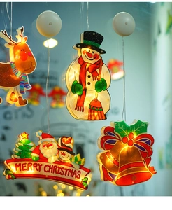 Close-up of reindeer and snowman LED suction cup lights for window decoration