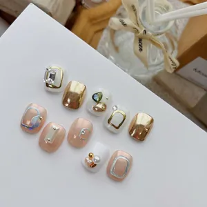 Luxury press-on nail kit featuring gold foil, large diamonds, and 3D metallic charms