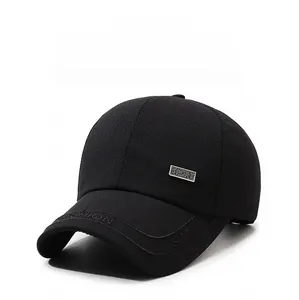 Close-up of black baseball cap featuring herringbone texture and metal sport emblem