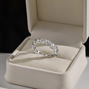 Macro shot of silver eternity ring with bezel set cubic zirconia in a jewelry gift box