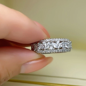 Macro view of wide silver ring with marquise cut leaves and round white zircons