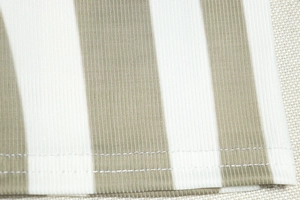 Macro detail of khaki ribbed fabric with white stripes and double-needle hem sewing
