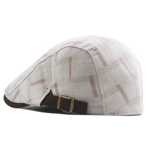 Detail of classic plaid ivy cap featuring an adjustable metal buckle and cotton fabric