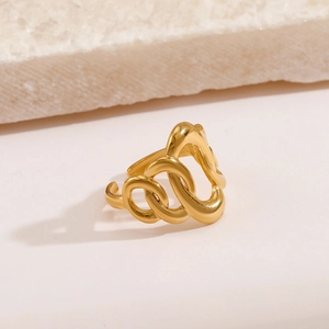 Polished gold irregular wavy oval stainless steel open ring on marble surface