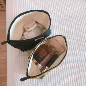 Quilted fabric cosmetic bags in black and beige showing large storage capacity