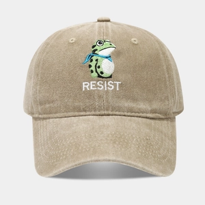 Close-up of a green frog embroidery and RESIST text on a khaki washed cotton baseball cap