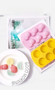 Close-up of fruit-shaped silicone molds with DIY pineapple and citrus candy results
