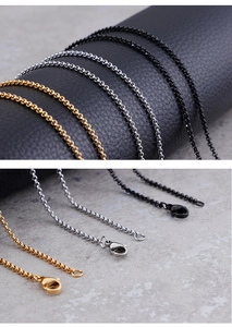 Detail view of O-chain necklaces in gold, silver, and black with lobster clasps