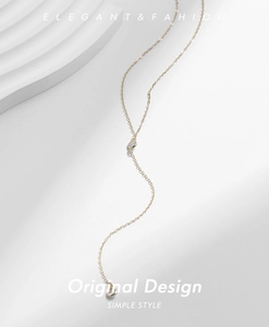 Detailed view of 925 sterling silver golden Y-shaped necklace with round sparkling gemstone