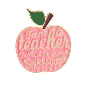 Detail of pink enamel apple brooch with I am a teacher what is your superpower text