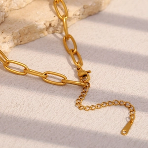 Detail of adjustable lobster clasp and extension chain on 18K gold plated paperclip necklace