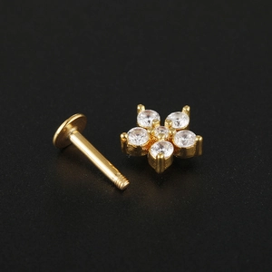 Macro view of gold flat-back ear stud featuring a crystal flower with five clear zircons