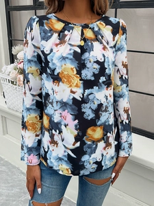 Close-up of bohemian floral print blouse with pleated round neck and long sleeves