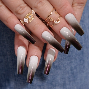 Detailed view of long coffin nails with white to deep purple gradient and fine glitter