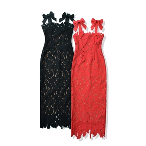 Close-up of intricate hollow lace texture and ribbon bow straps on midi dresses