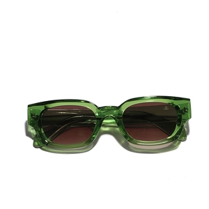 Retro cat-eye sunglasses with translucent jelly green frames and dark brown lenses