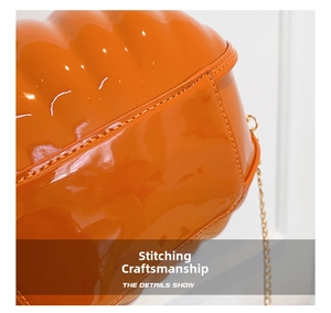 Detail shot of precise stitching craft on orange patent leather pumpkin bag