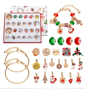 Close-up of DIY Christmas advent calendar set with 24 gold bracelets and holiday charms