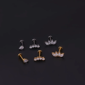 G23 titanium flat back labret studs with teardrop zircon and leaf crown designs