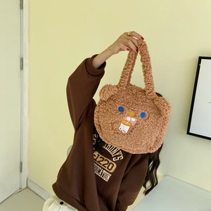 Detail of cute brown faux shearling handbag featuring teddy bear face and milk tea embroidery