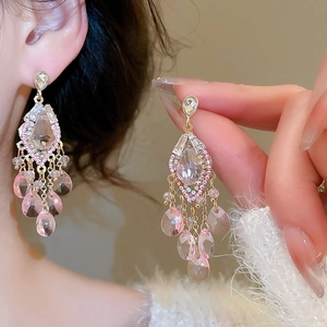 Detail of pink crystal tassel earrings with long multi-layered teardrop pendants
