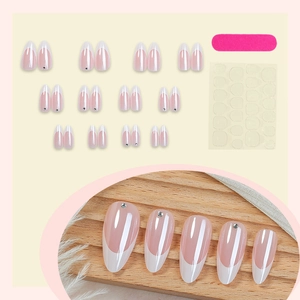 French almond press-on nails set with rhinestones, glue, and file in elegant packaging