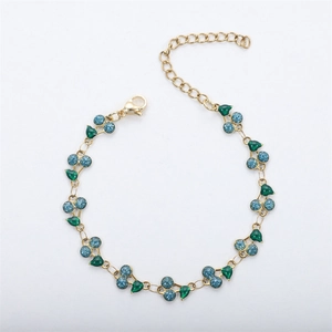 Detail showing the 18k gold chain, lobster clasp, and blue glitter cherry pendant