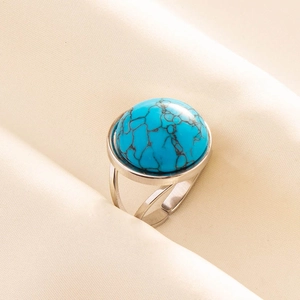 Macro detail of bohemian turquoise ring with adjustable silver-tone band and stone texture