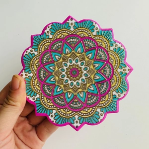 Detailed view of bohemian mandala ceramic coaster with gold stamping and floral edge