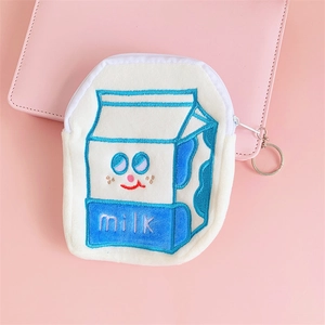 Close-up of a cute milk carton shaped plush coin purse with embroidered details and zipper
