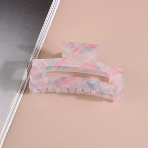 Macro shot of a rectangular pink and blue marble pattern acetate hair claw clip