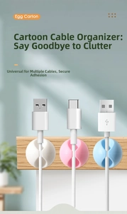 Detailed view of colorful round silicone cable clips in white pink and blue on a desk