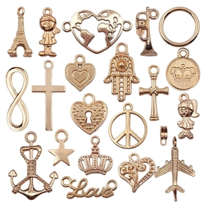 Golden KC alloy assorted charms set including plane, anchor, heart, and crown on white background