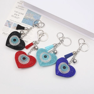 Set of four sparkling rhinestone heart and evil eye keychains with colorful leather tassels