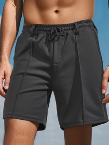 Detail of grey mesh quick-dry shorts featuring breathable texture and drawstring waist