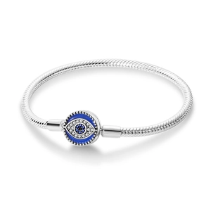 Detail of silver snake chain bracelet featuring an Evil Eye clasp with blue enamel