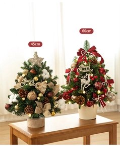 Detail of 45cm and 60cm luxury Christmas trees with warm LED lights and festive ornaments
